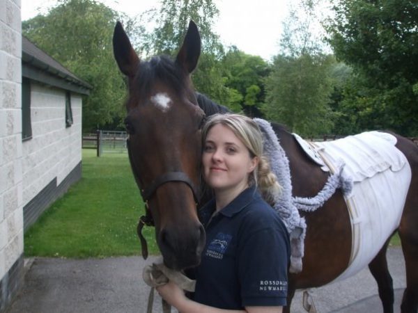 Blonde woman and a brown horse