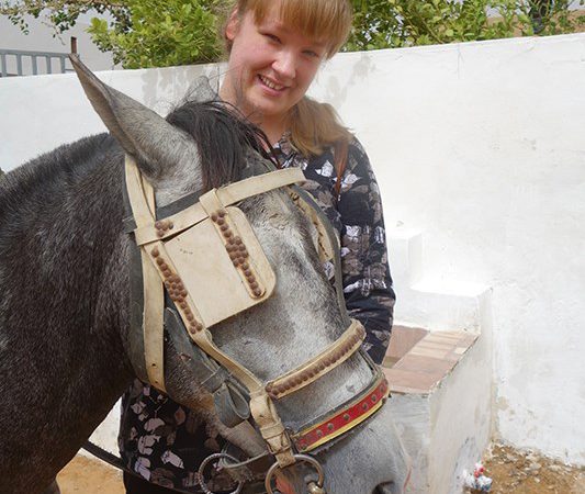 Smiling woman and a horse