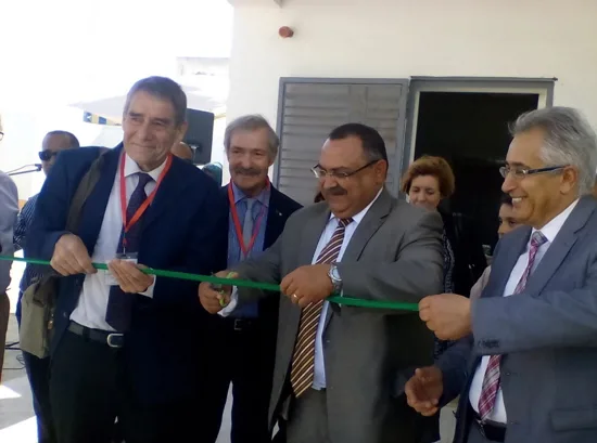 Man is cutting ribbon at opening ceremony