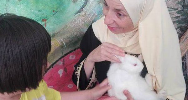 Women holding white rabbit