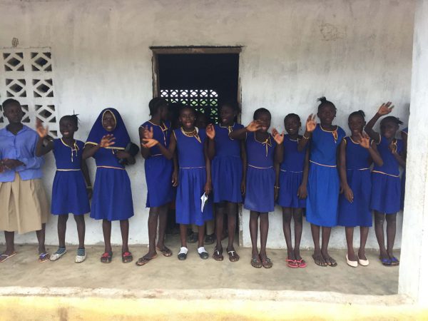 Schoolgirls in a line waving