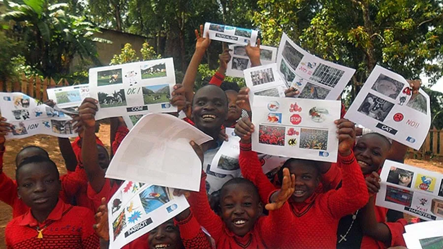 Group of children holding up pieces of paper