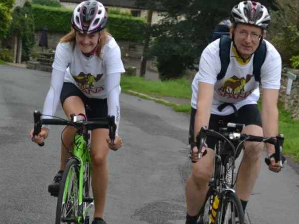 Anna Marie and her dad cycling in SPANA tshirts