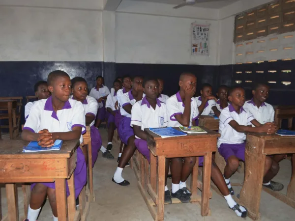 Schoolgirls sitting at desks in classroom