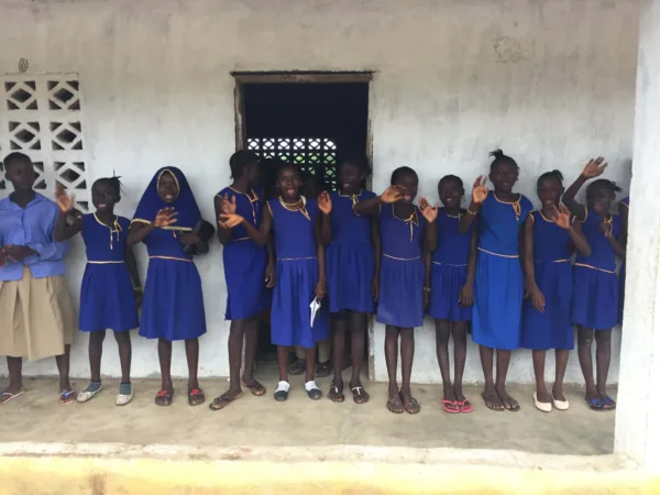 Schoolgirls in a line waving
