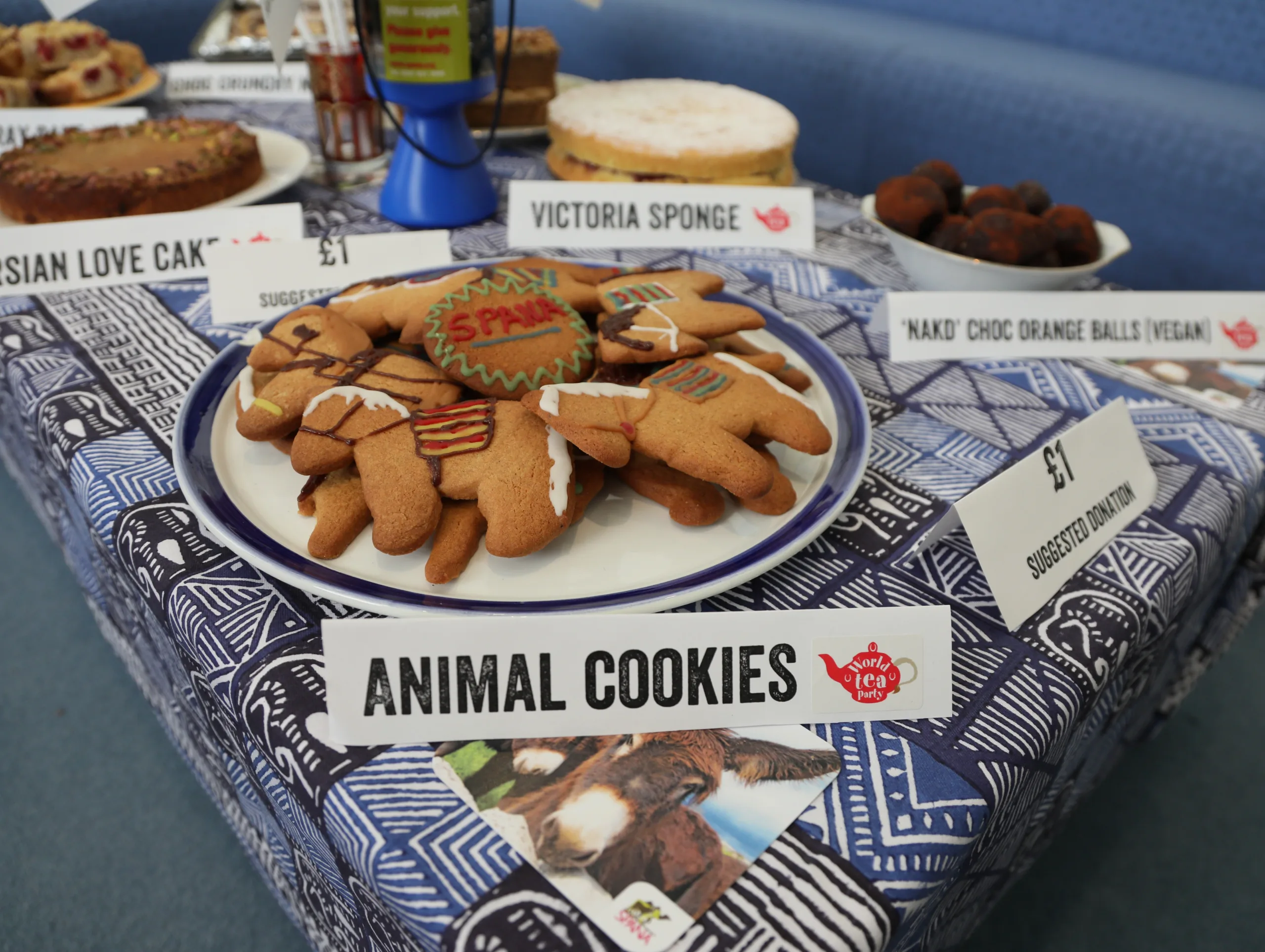A plate of animal-shaped cookies on a table, raising money for SPANA charity