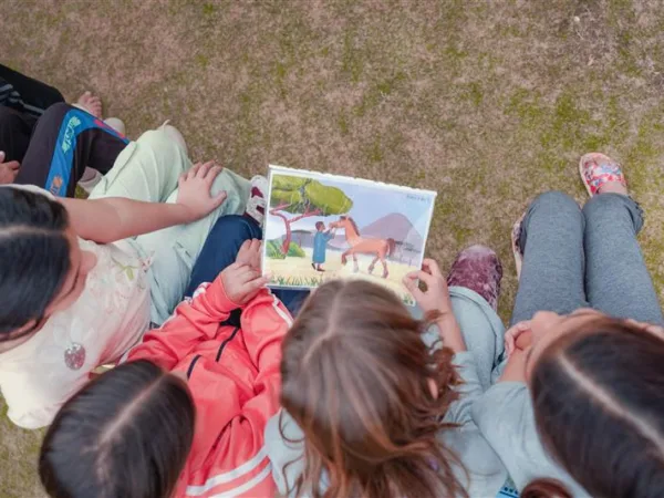 Chidlren learning at PAWS club from resources